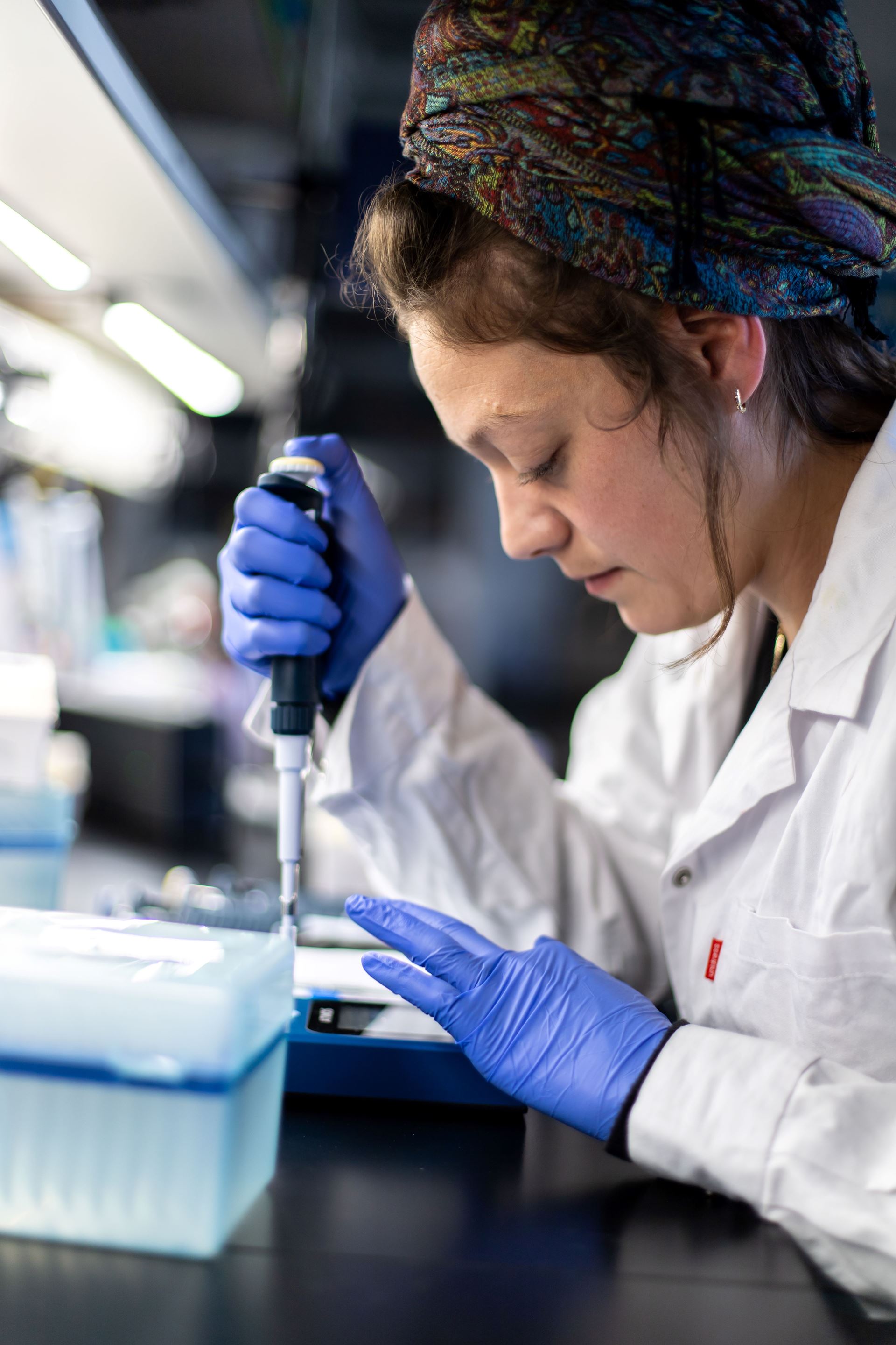 Researcher using a pipette